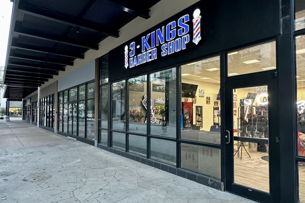 Outside of a barber shop with glass windows