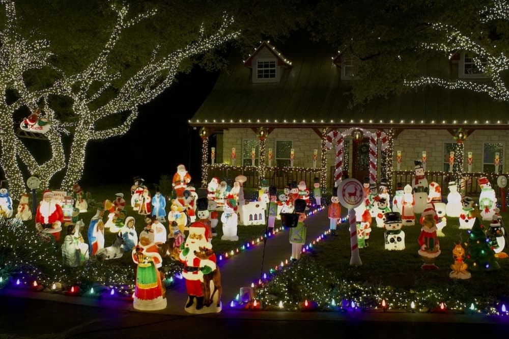 The front yard of the Maywald house is lit up with Christmas figurines. (Elle Bent/Community Impact)