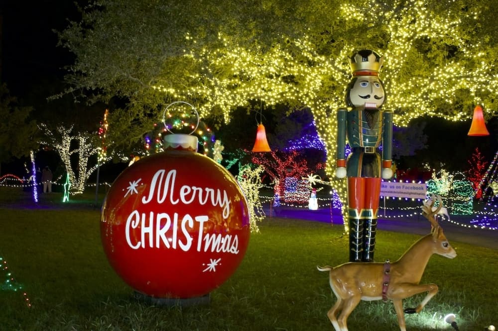 A larger-than-life nutcracker and ornament sit on the left side of the path of the display. (Elle Bent/Community Impact)