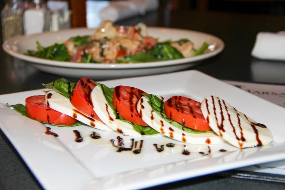 Tomato Caprese Salad ($9.95): Fresh mozzarella, basil leaves and sliced tomatoes are drizzled with a balsamic reduction and extra virgin olive oil. (Wesley Gardner/Community Impact) 