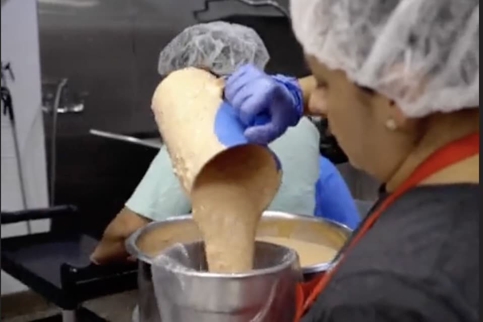 woman pouring banana bread batter