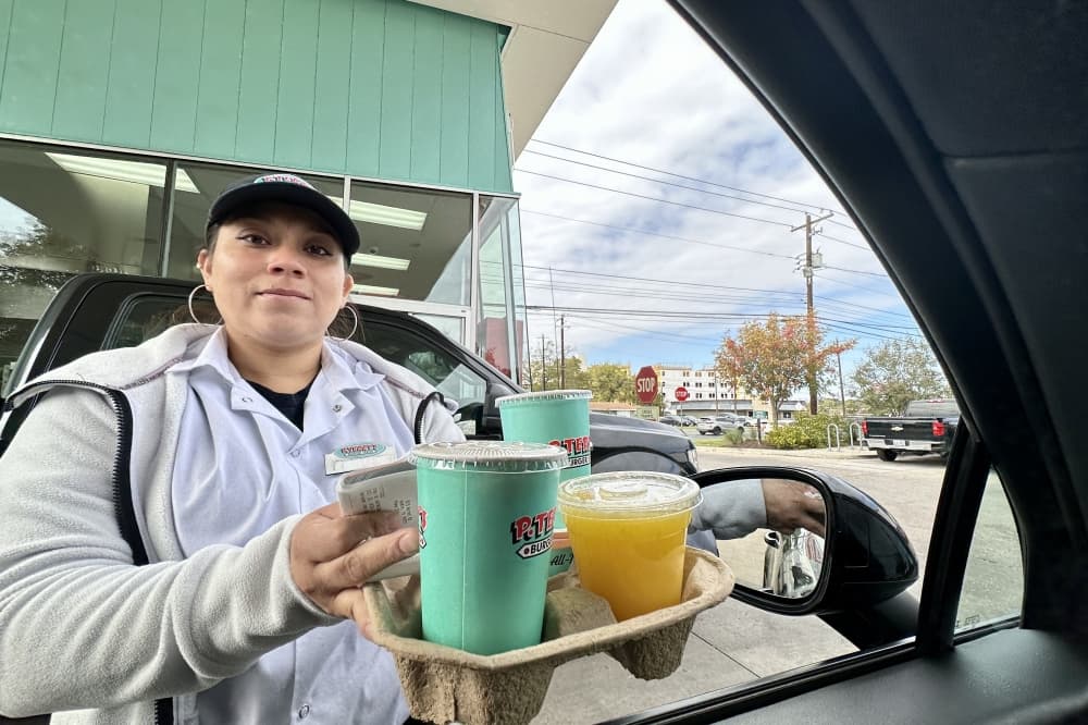 woman bringing food out to car