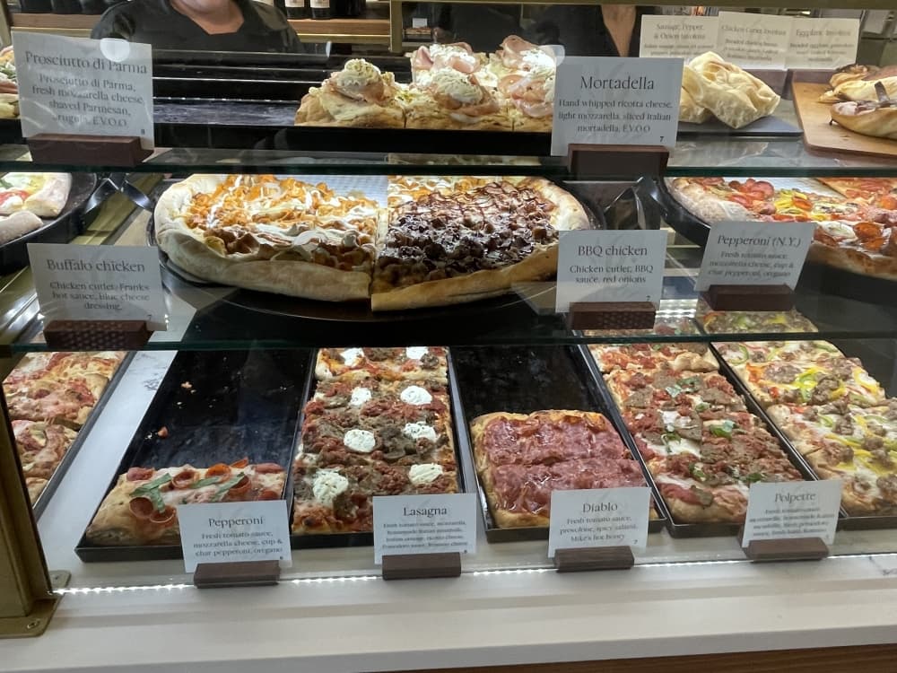 pizzas on glass display shelf 