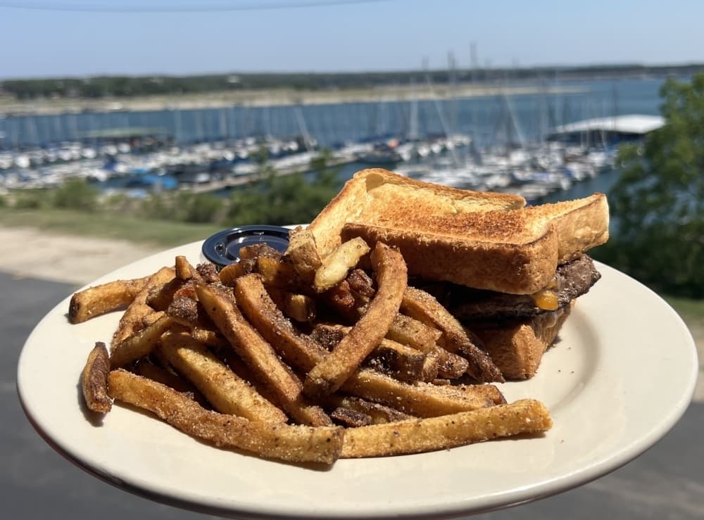 texas patty melt at sundancer grill with views of lake travis in the background