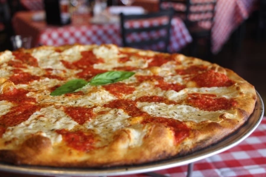 a pizza with cheese and basil