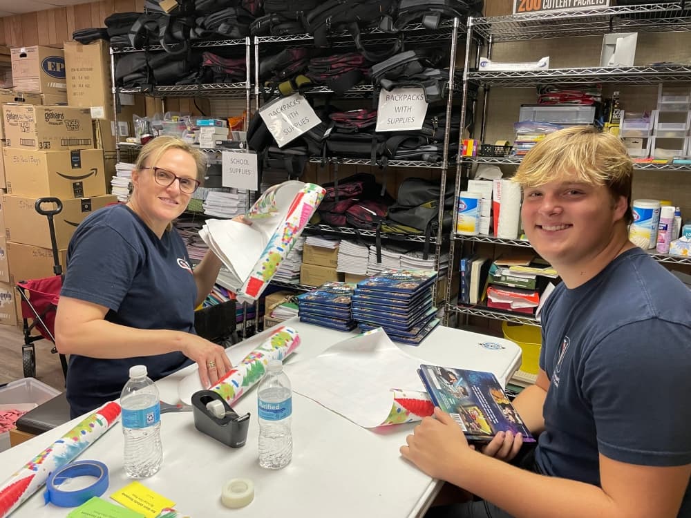 Luke and Sharon Miller were just one of several mother-son pairs who wrapped books for the YMSL Ultimate Gift project.  (Courtesy Kasey Baize)