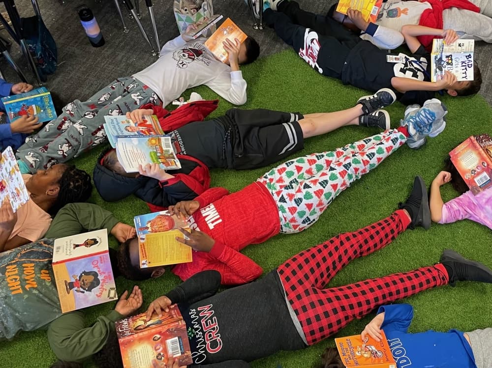 A third grade class enjoys the books they were delivered by the Young Men's Service League. (Courtesy Kasey Baize)