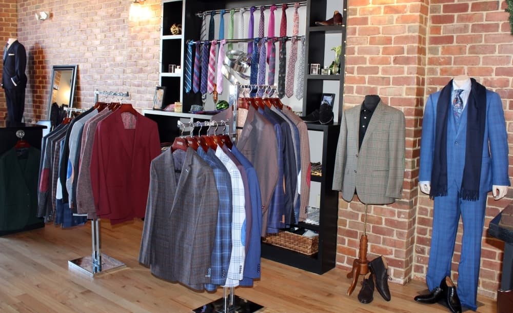 Clothing on racks and mannequin at Lombardo Custom Apparel