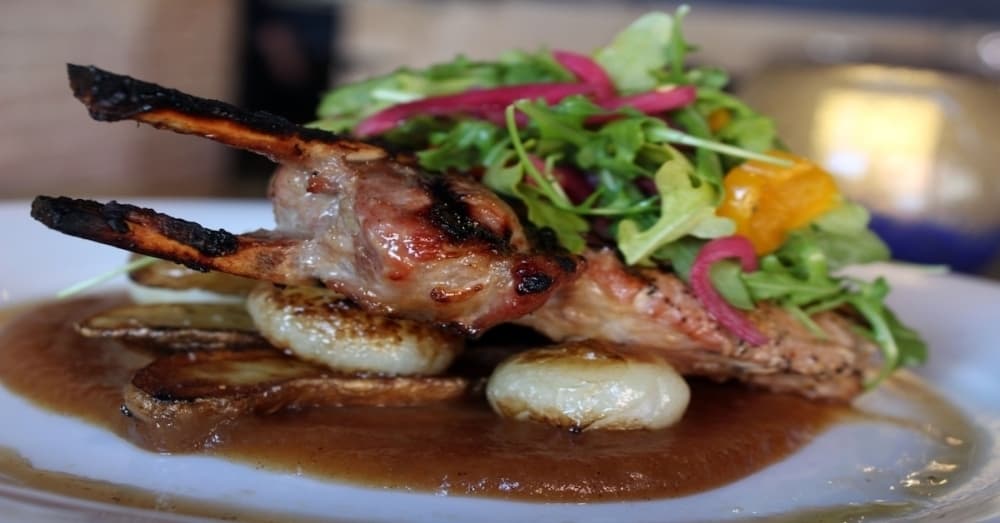 On the menu at Urban Grill and Wine Bar: The pork chop ($28) includes apple sauce, cippolini onions, fingerling potatoes and arugula. (Karen Chaney/Community Impact Newspaper)