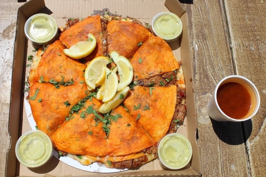 The Birria PizzaDilla from Tejas Birria is filled with over a pound of beef, cheese and onions, and served like a pizza. (Eric Weilbacher/Community Impact)