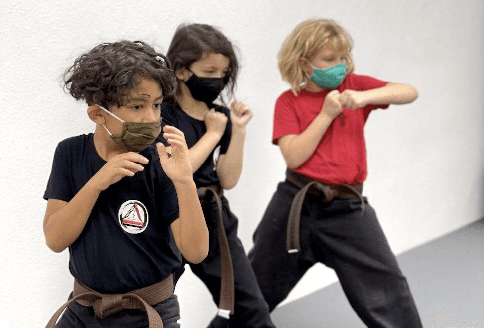 close up shot of kids with masks on practicing at next gen mu sool