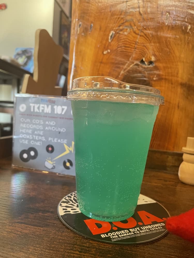 blue-green drink in plastic cup