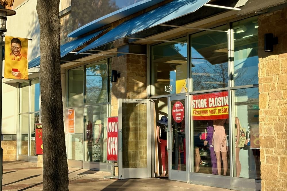 Outside of a store with a closing sign