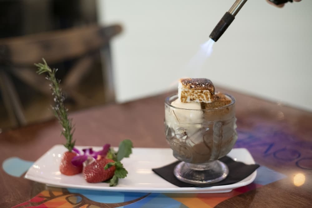 S’mores Toasted Tableside ($13) is a honey Graham Cracker cake made with chocolate mousse, ganache, salted caramel gelato and homemade marshmallow. 