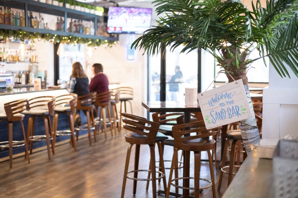 Good Vibes Coastal Kitchen features a large mural of a beach scene, island music, palm trees and fish swimming on the TV screens can be found in the restaurant. 
