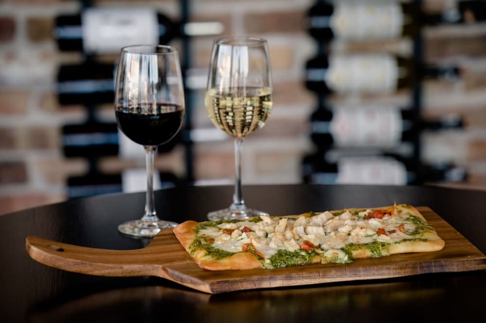 Pesto chicken, mozzarella and tomato flatbread ($17): A flatbread pizza is topped with chicken, pesto, roasted tomatoes and mozzarella. (Courtesy The Classy Cork/Tiffany Hofeldt Photography)