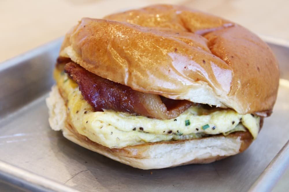 The bacon, egg and cheese sandwich ($7) is made with thick-cut bacon, cage-free scrambled eggs, Tillamook cheese, chives, and chipotle mayo. (Photo by Karen Chaney)
