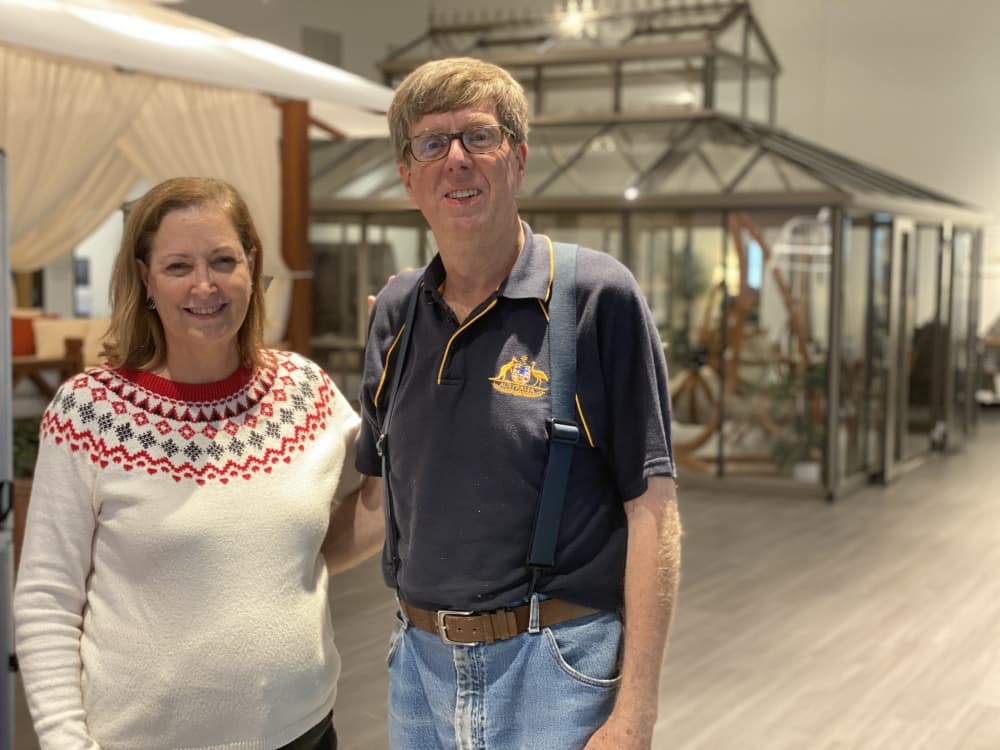 owners in front of greenhouse