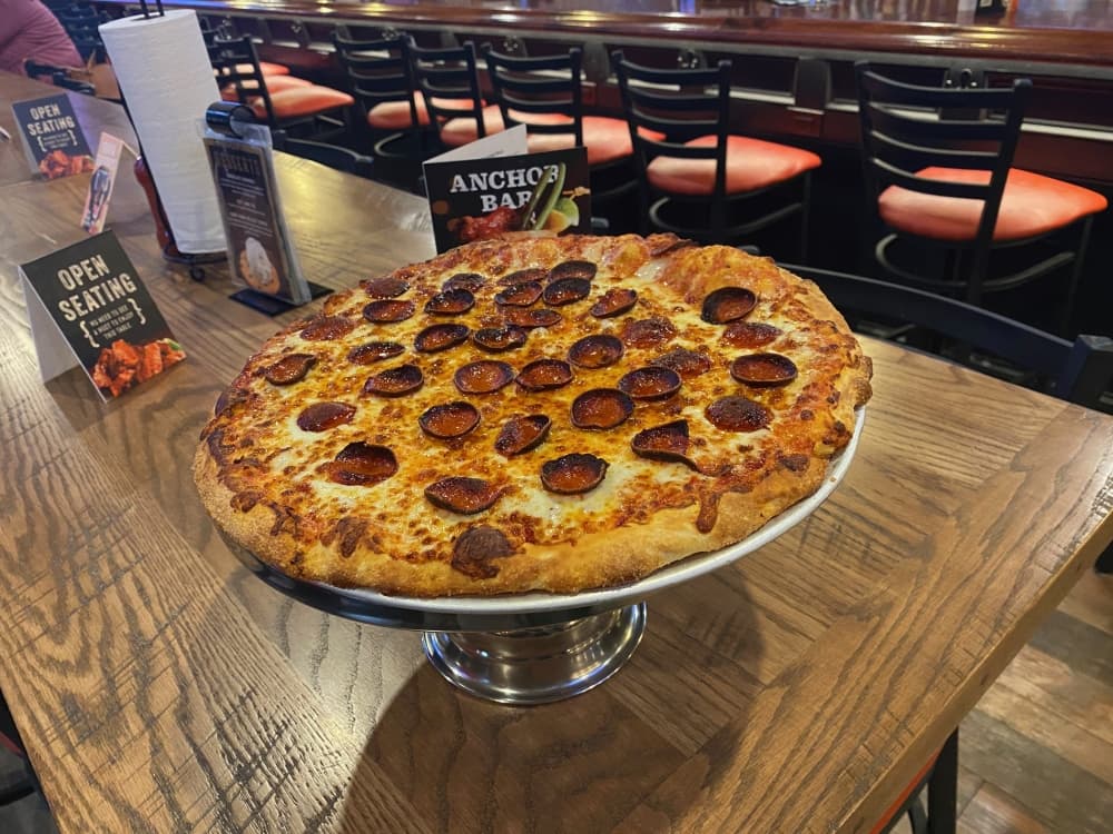 pepperoni pizza on a table near a bar