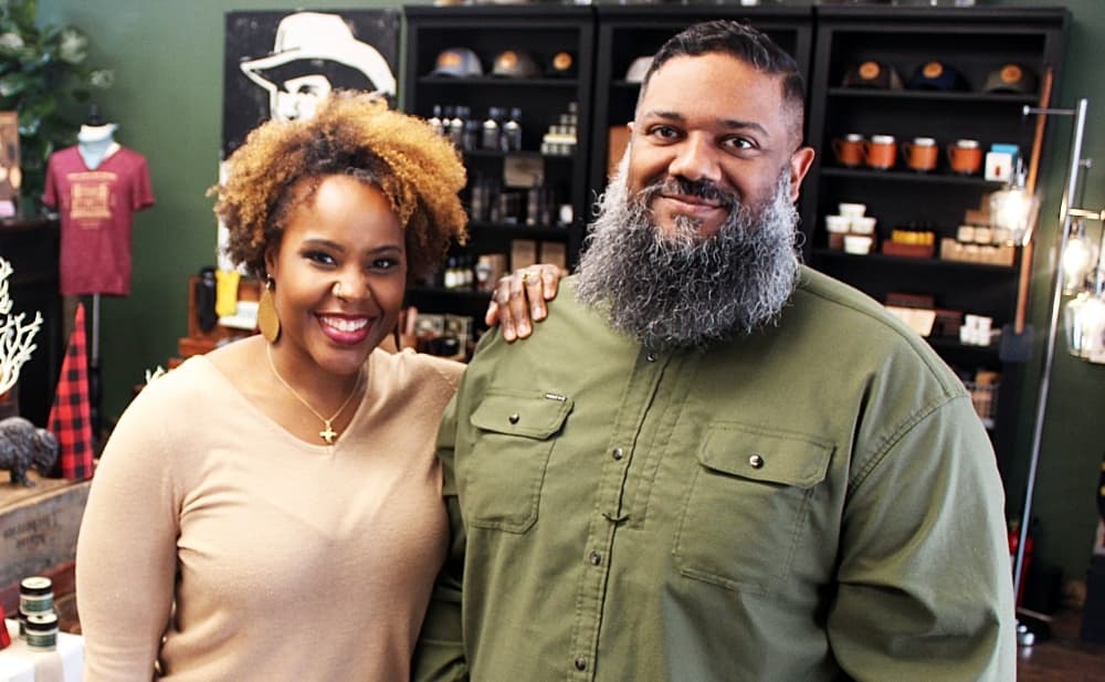 The owners of Odin Leather Goods stand inside their store. 