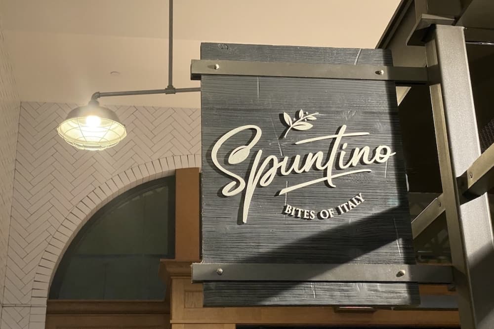 grey sign with text that reads Spuntino, bites of Italy