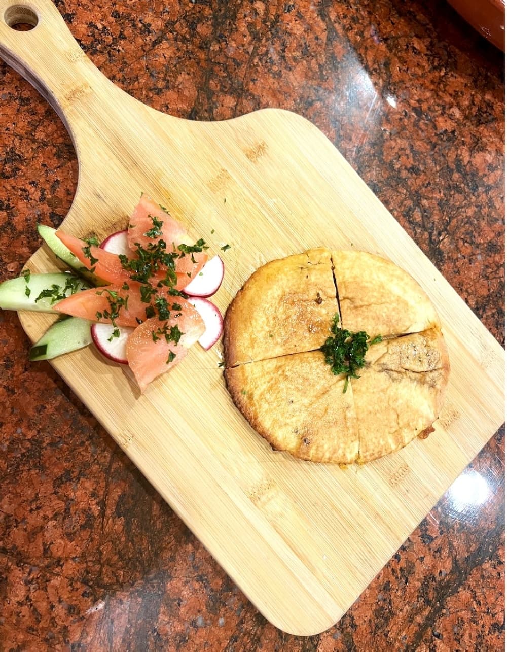 pita bread and vegetables on wooden serving board 