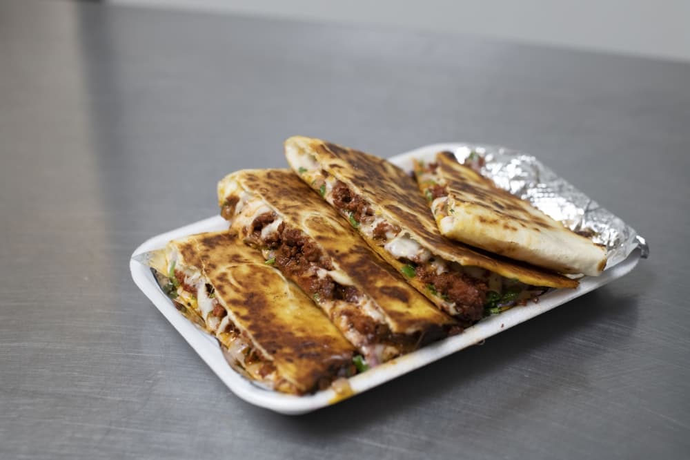 USDA prime skirt steak in a 12-inch toasted flour tortilla with mozzarella cheese, onions, cilantro, topped with Kronik Sauce and Lean Sauce.