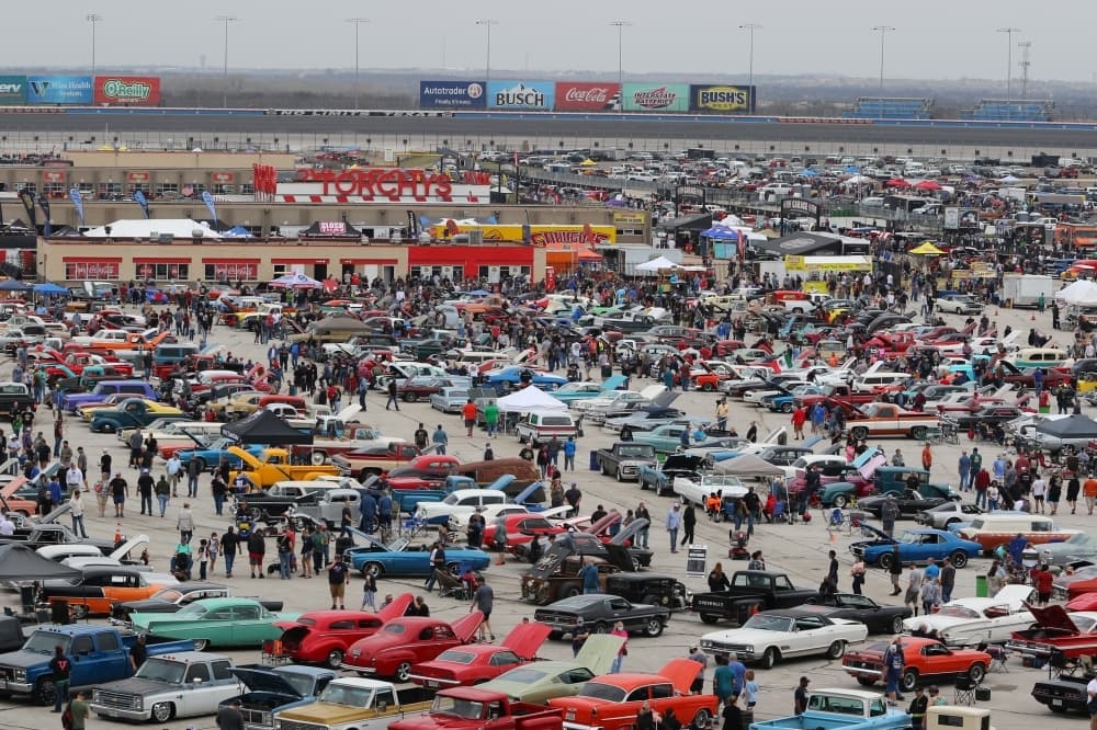 Cars parked in a lot for a car show. 