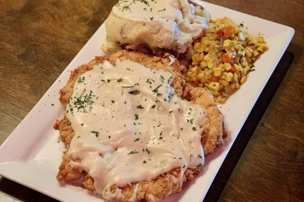 Chicken fried steak with corn and mashed potatoes