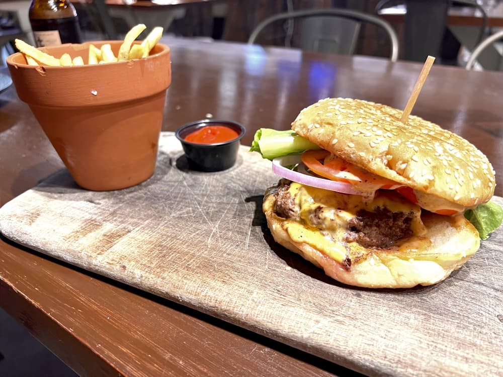 The DOM short-rib/brisket burger comes with a secret sauce and American cheese on a sesame seed bun ($14). (Zara Flores/Community Impact)