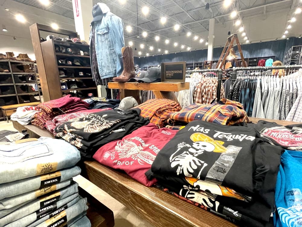 tee shirts folded on table in store 