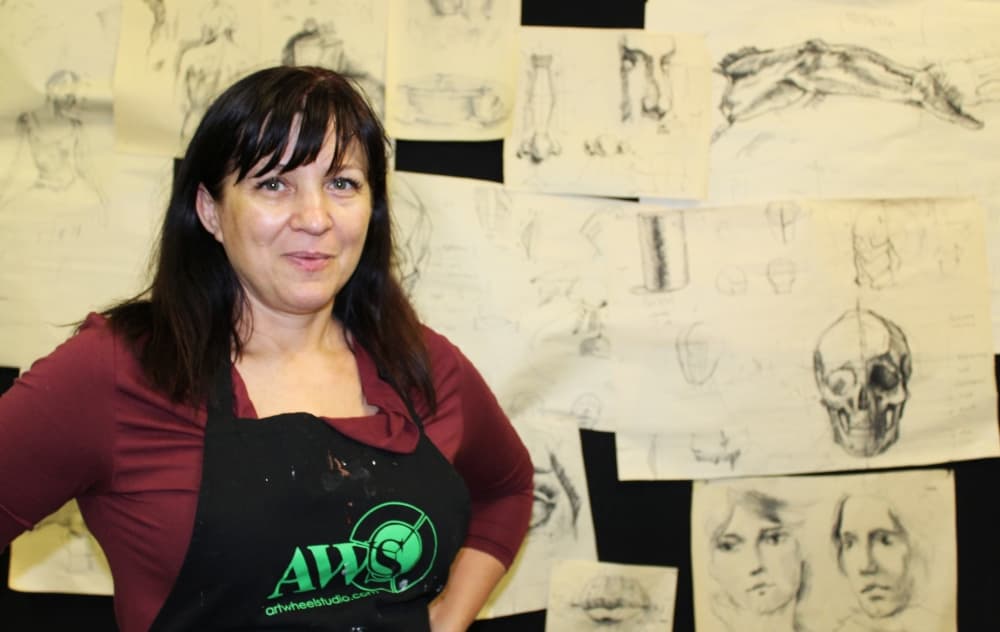 Liliana Nedzelska and her son Stanislav Nedzelskyi were chosen to paint a mural in downtown Roanoke. Their design depicts elements of historic Roanoke. (Karen Chaney/Community Impact)