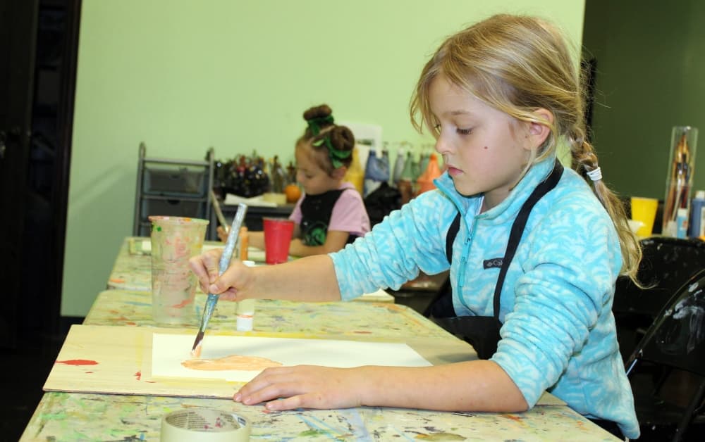 Anna Charaevski begins a painting in a group class. (Karen Chaney/Community Impact)