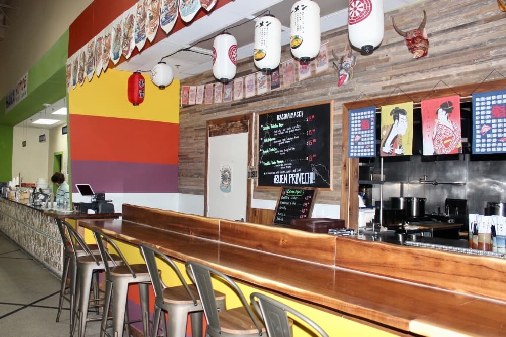 Bar with stools and a menu on a chalk board