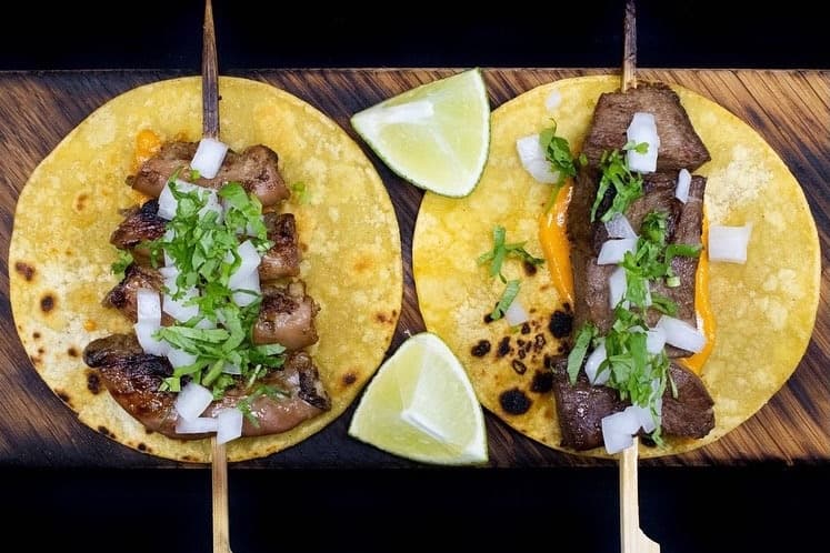Meat, cilantro and lemon on two tortillas