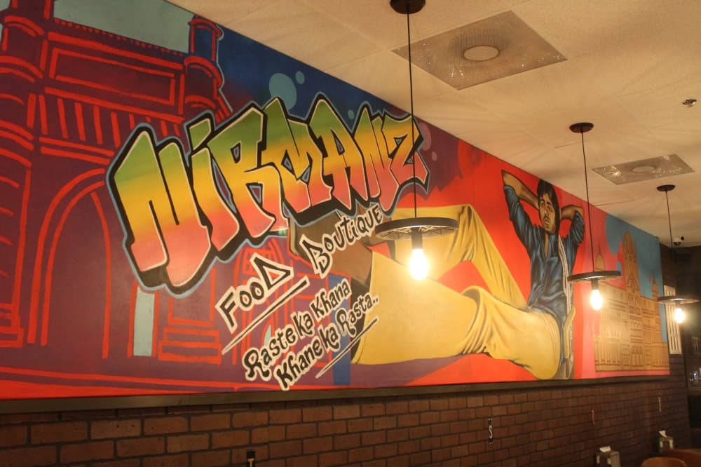 A mural gives tribute to famous Bollywood actor Amitabh Bachchan. (Renee Farmer/Community Impact)
