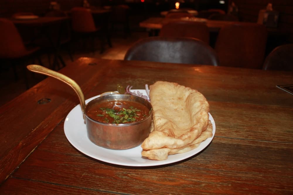 Cholay bhature: Chana masala is served with deep-fried naan bread. (Renee Farmer/Community Impact)