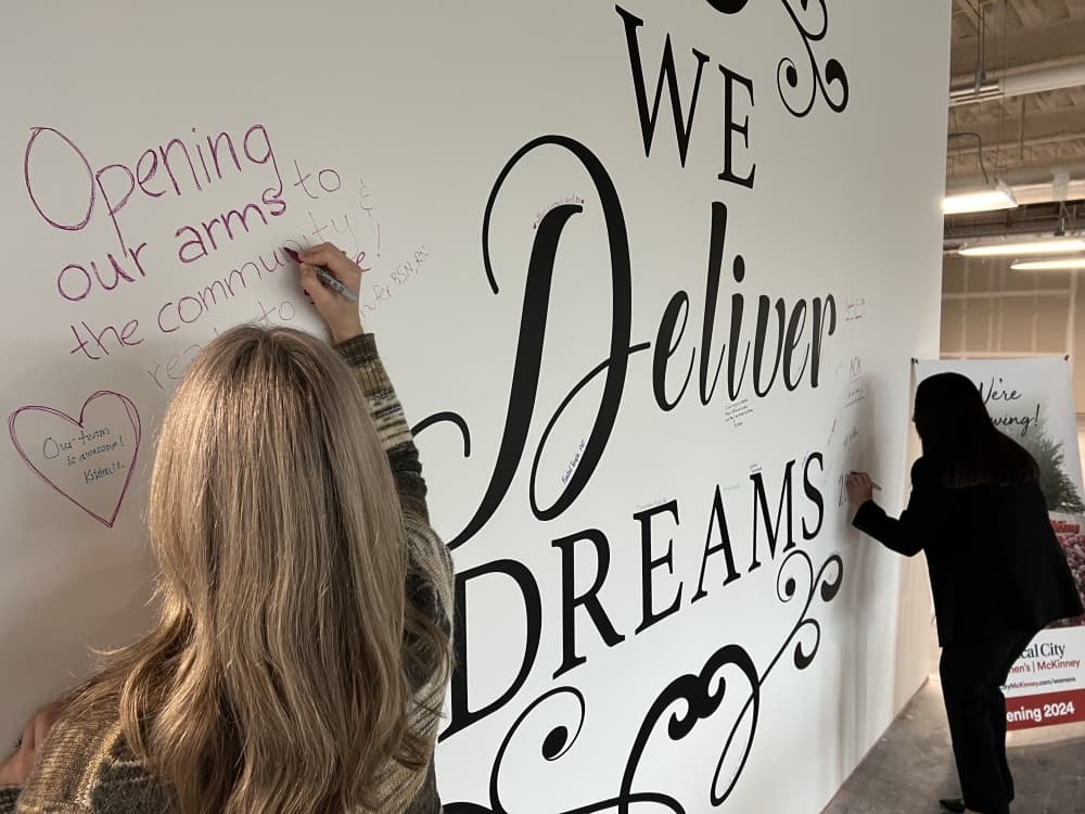 Medical City McKinney staff signing the wall at the event