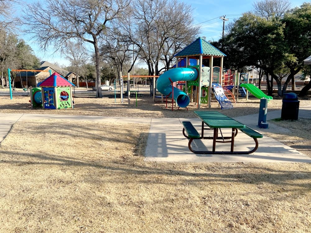 playground with plastic picnic table, slides