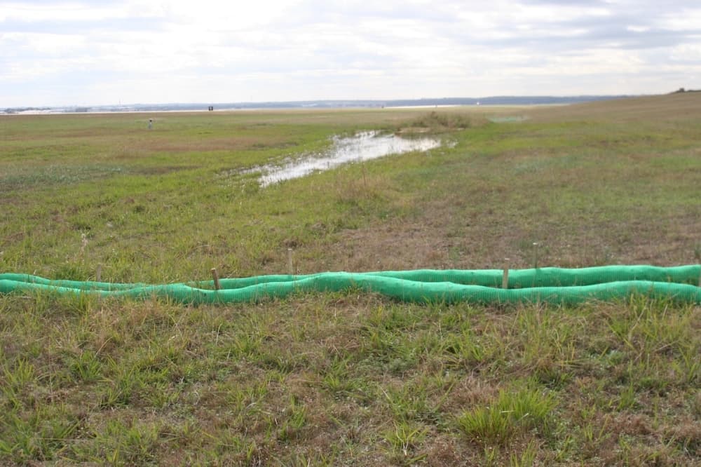 A protective barriers placed around the wetland to prevent mud from flowing downstream. (Courtesy ABIA)