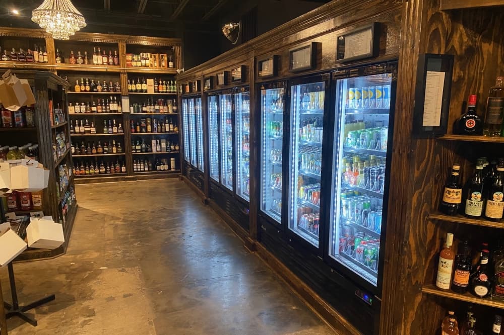 Beer fridges and wooden shelves in a liquor store