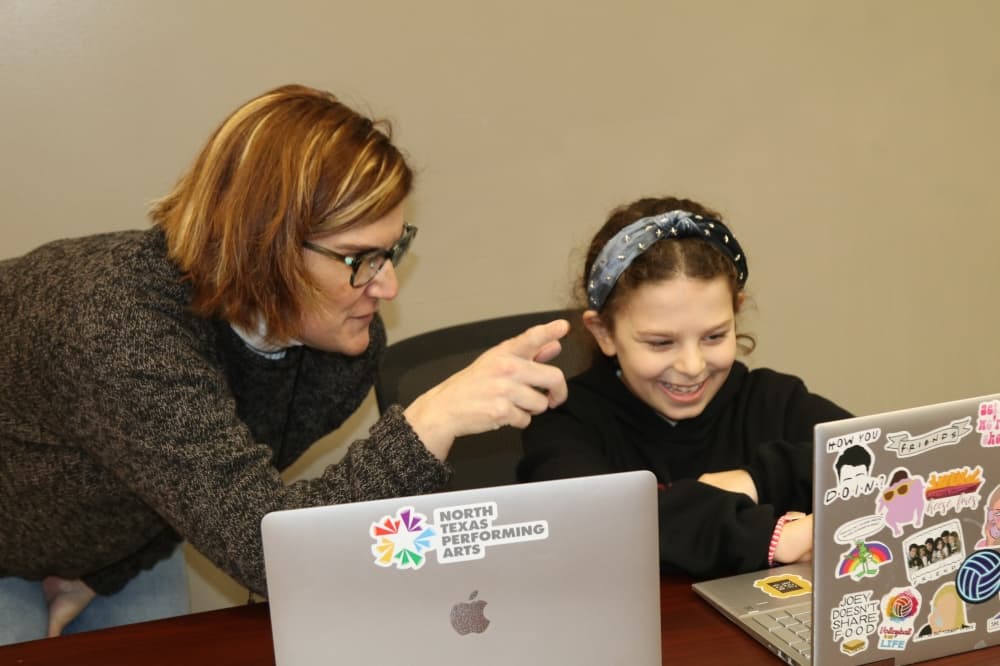 Core Academic Head Lyz Miller assists a student with schoolwork. (NTPA)