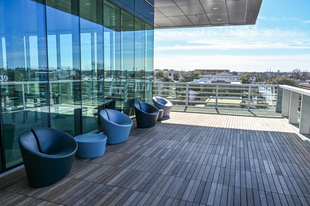 patio of library has modern furniture for patrons to sit and look at the view 