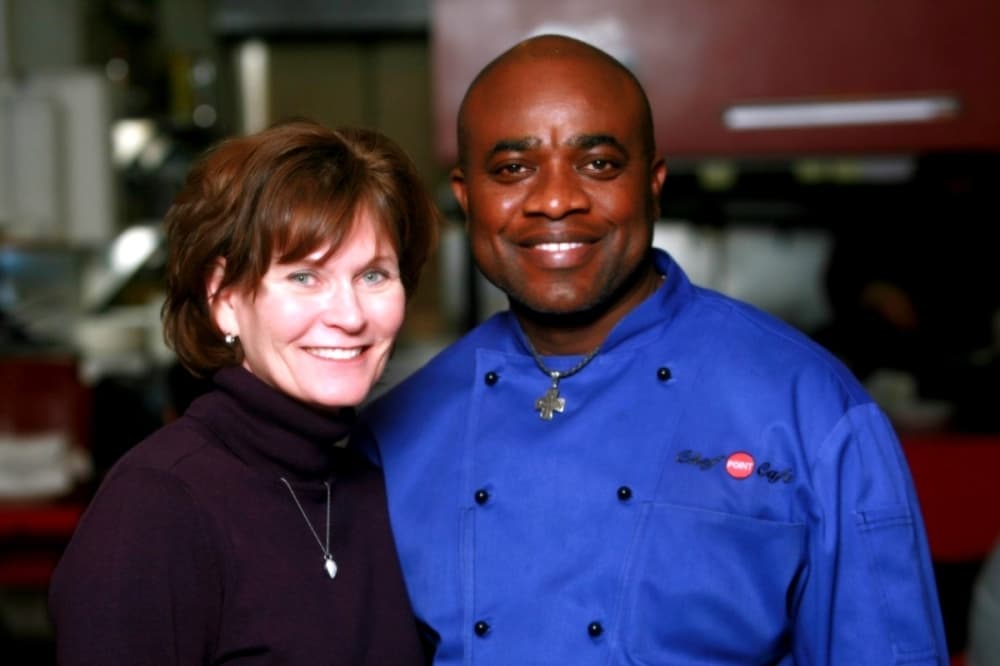 Paula Merrell Nwaeze and Chef Franson Nwaeze stand inside the kitchen at their resturant.