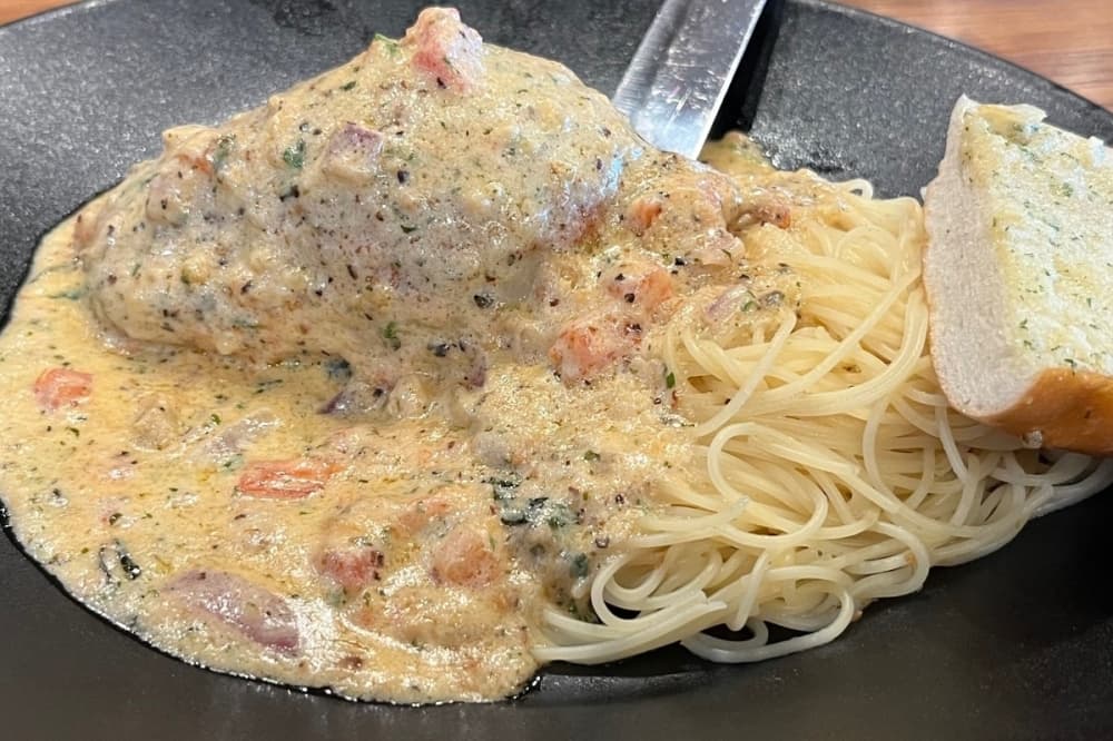 Blackened Stuffed Chicken ($31) is smothered in Asiago sauce and stuffed with aged pepper jack cheese and crabmeat.