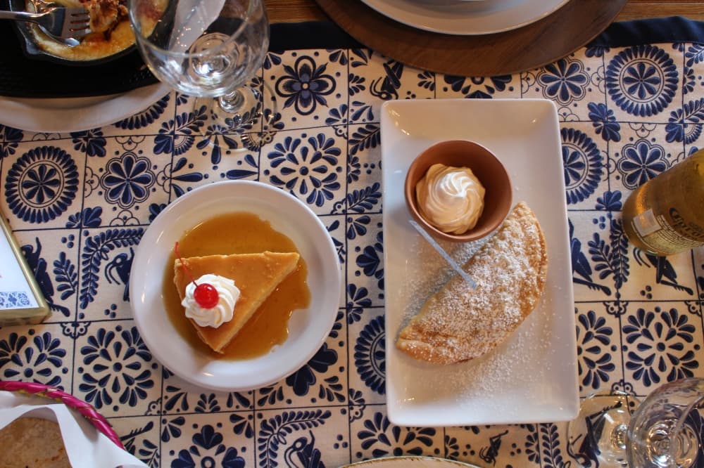 Empanadas de manzana ($4.50) are made with an apple, walnut and raisin filling. Flan napolitano ($5.00) is a custard dessert with caramel. (Kylee Haueter/Community Impact)
