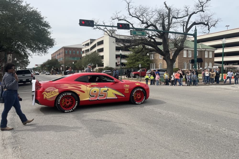 A car resembling Lightning McQueen drives through the Go Texan Parade on Feb. 18. (Peyton MacKenzie/Community Impact)