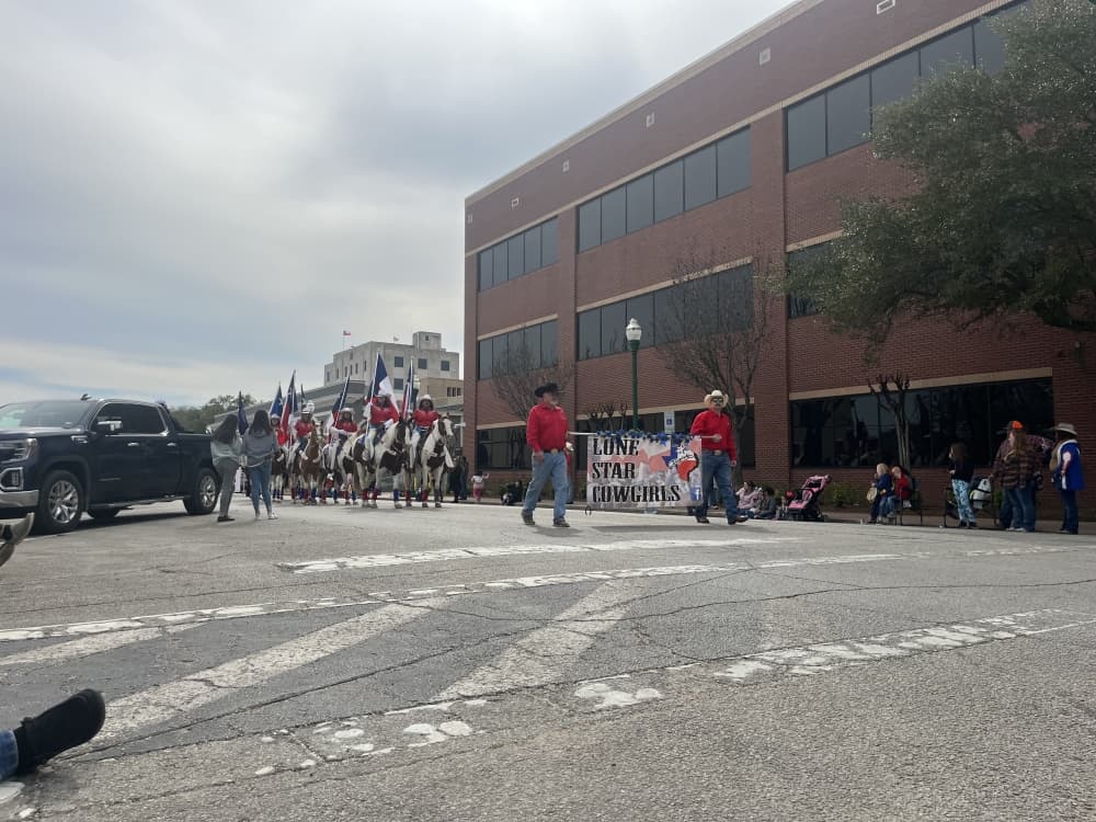 The Lonestar Cowgirls ride through the Go Texan Parade on horseback. (Peyton MacKenzie/Community Impact)