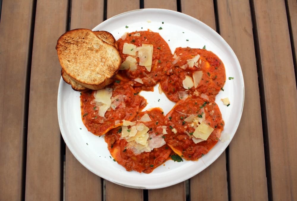 Ravioli di burrata alla Bolognese is homemade burrata cheese-filled ravioli. 