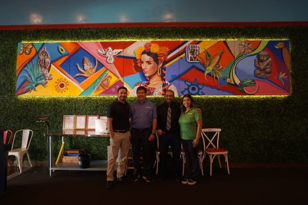 People standing in front of mural